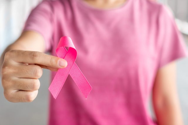 October Breast Cancer Awareness month, Woman in pink T- shirt wi